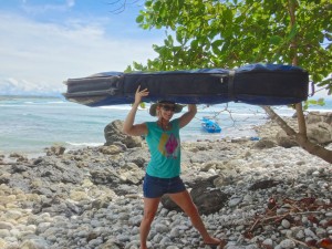 Aloe Driscoll carrying surfboards in Costa Rica.