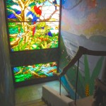 Staircase stained glass window and mural of Pavones.
