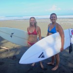 Aloe and Michelle surfing near Pavones, Costa Rica.